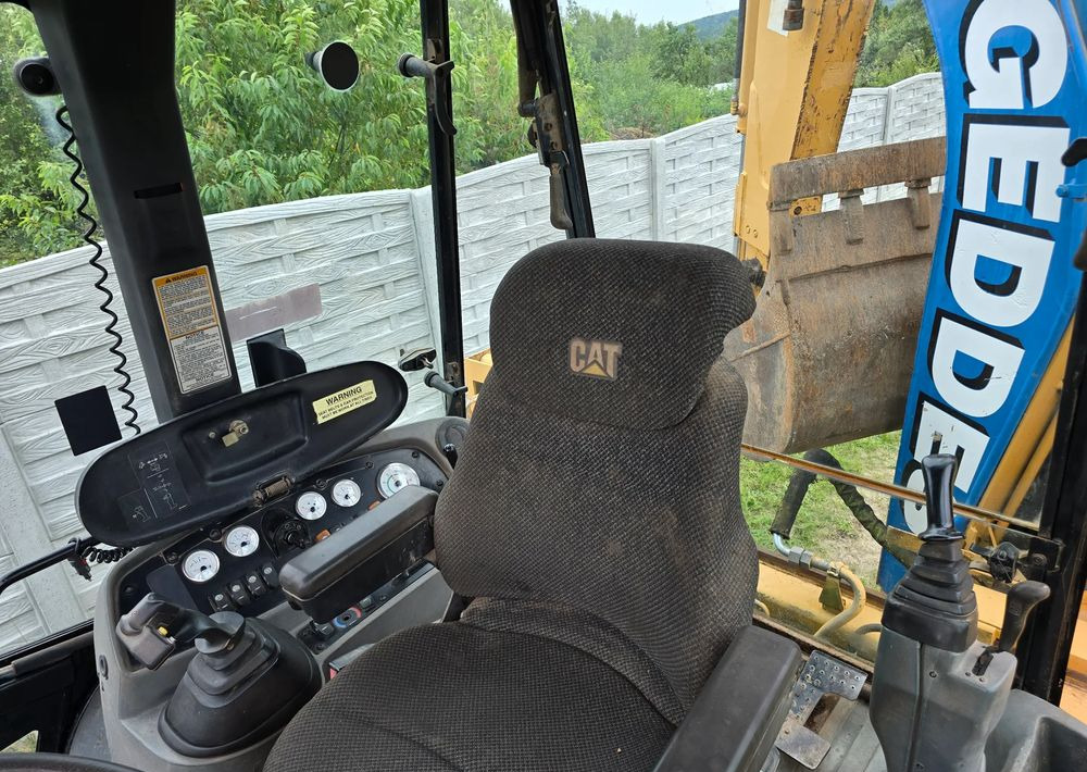 Caterpillar - Bager utovarivač: slika 2 Caterpillar - Bager utovarivač: slika 2