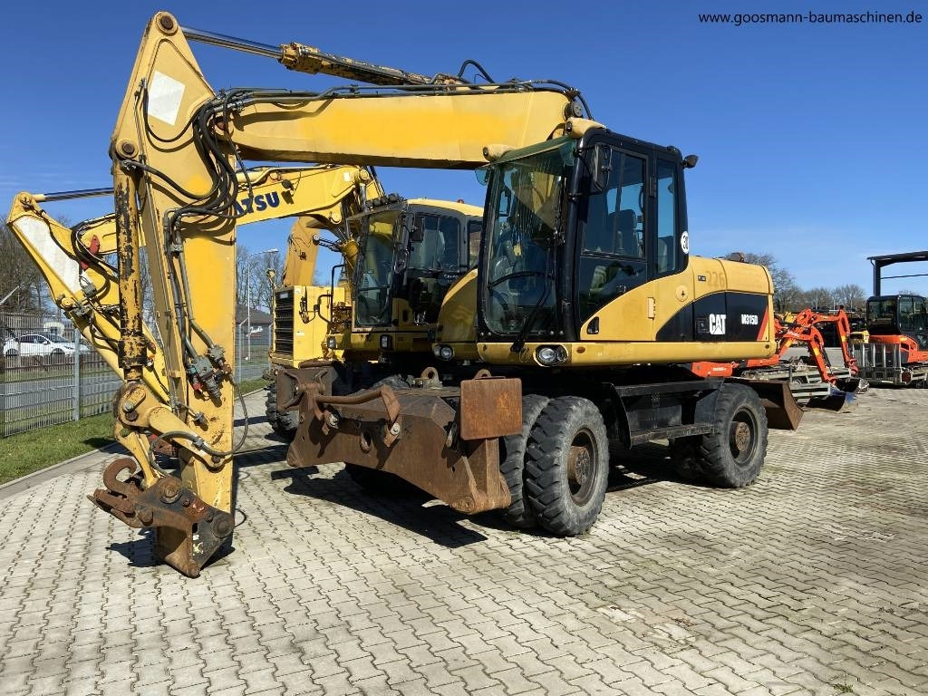 CAT M 315D - Bager točkaš: slika 1 CAT M 315D - Bager točkaš: slika 1